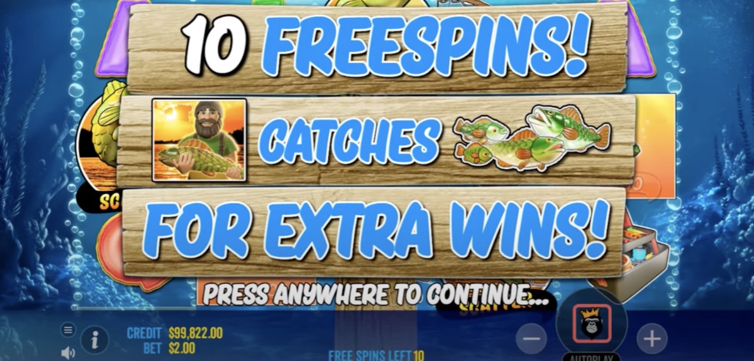 Big Bass Bonanza free spins screen. The image announces "10 Free Spins" in big bold letters at the top. Below it is written "Catches for Extra Wins!" with images of a fisherman holding a fish and a group of fish on the right. The background is made of wood, similar to a road sign